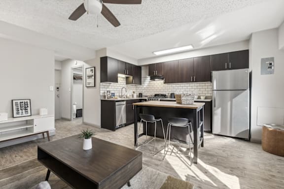 A modern kitchen with a dining table and chairs.
