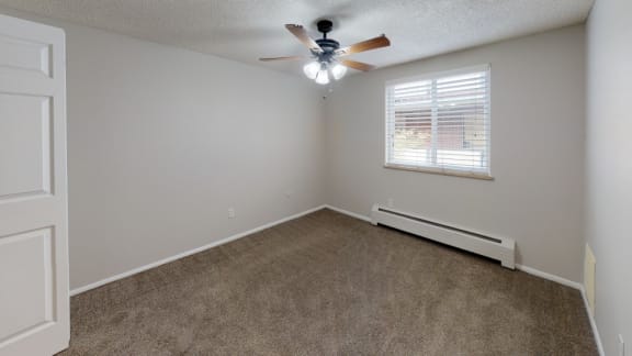 Bedroom Filled with Natural Light and Ceiling Fan at 1303 Columbine in Denver, CO