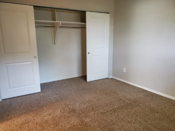 Spacious bedroom with a large double-door closet and cozy carpet—designed with storage and comfort in mind at 1444 Saint Paul St in Denver, CO