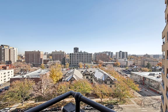 A cityscape with buildings and trees in the foreground.