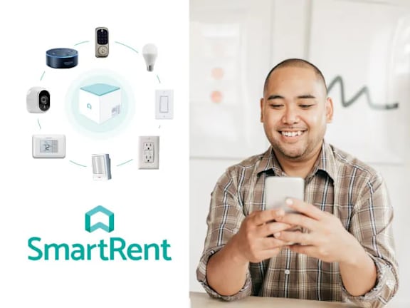 A man is using a smartphone with a SmartRent logo displayed.