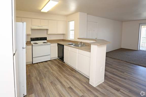 A kitchen with white appliances and cabinets.