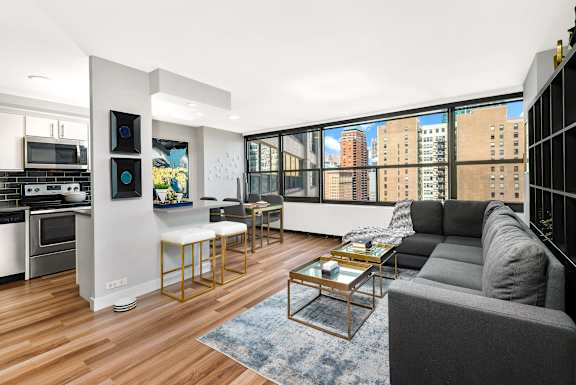 A modern living room with a grey couch and a coffee table.