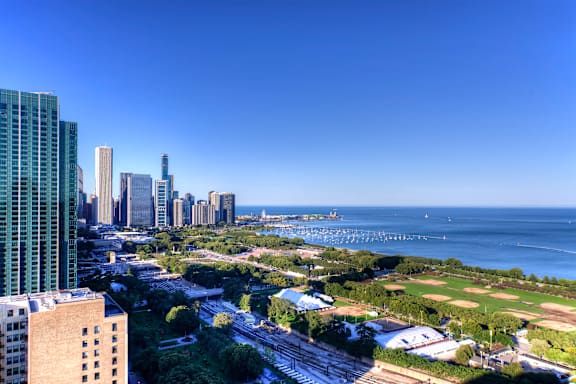 A cityscape with a view of the ocean from a high vantage point.