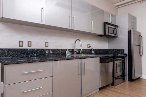 a kitchen with granite counter tops and stainless steel appliances