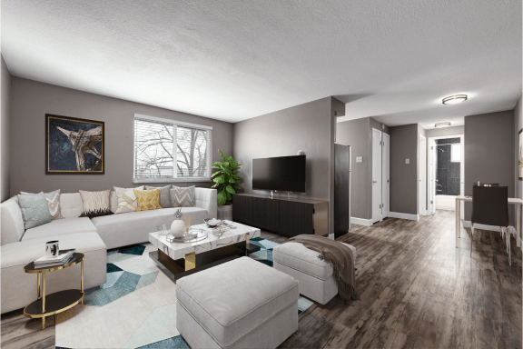 an open living room with a white couch and a tv