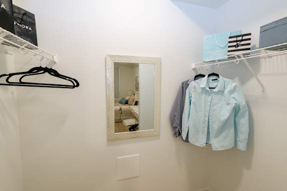 A mirror is mounted on a wall above a light switch.