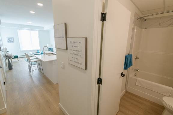 A bathroom with a towel hanging on the door.