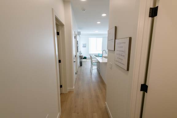 A long hallway with a sign on the wall.