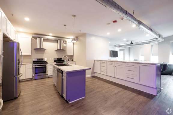 A kitchen with a purple cabinet and a refrigerator.