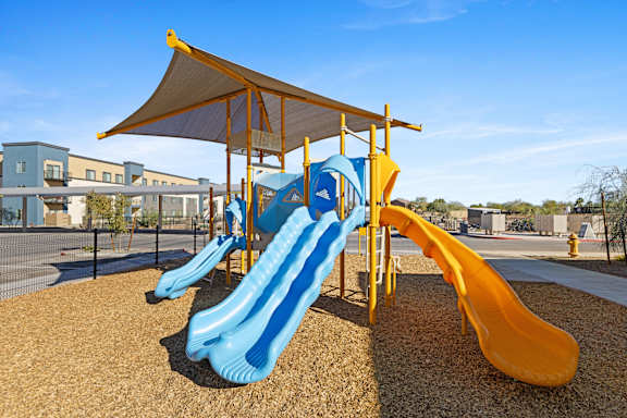 a playground with slides and a tent at Agave House Apartments, Casa Grande, AZ, 85122