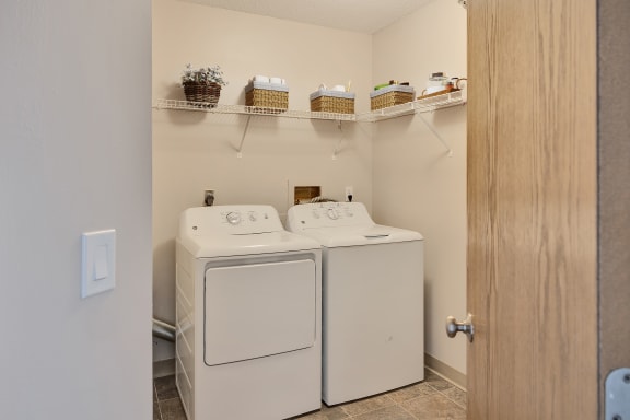a washer and dryer in a laundry room with a door to the room