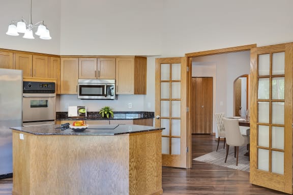 a kitchen with an island and a dining room