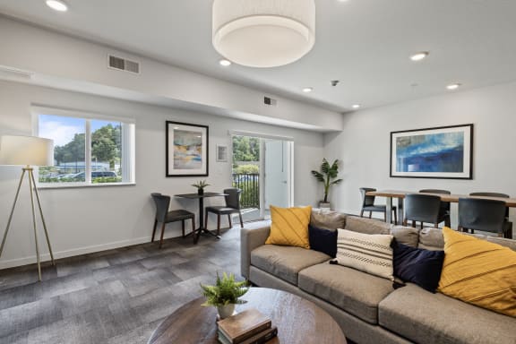 a living room with a couch and a table with chairs at EastGate Apartments, Rochester
