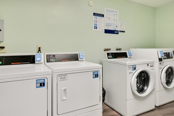 Washing machines and dryers in a laundry room at Pheasant Park Apartments, New Hope, MN