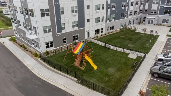 an aerial view of a playground in the middle of an apartment building