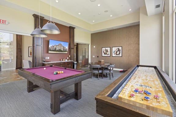 a game room with two pool tables and a billiard table at The Winslow 62+ Apartments, Minnesota