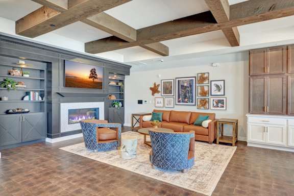 A living room with a fireplace and a television.