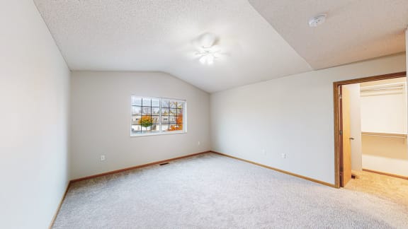 an empty room with a door to a closet