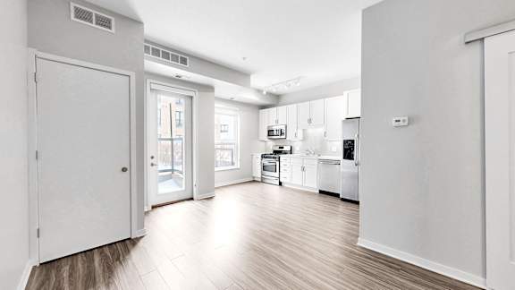 A kitchen with white appliances and cabinets.