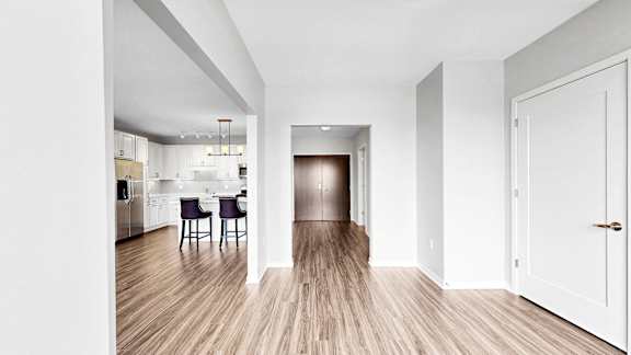 A long hallway with a dining area at the end.