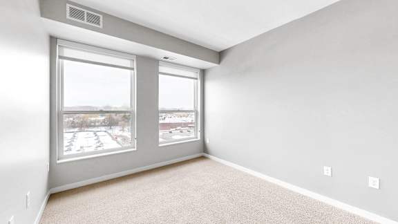 A room with a large window and a sliding glass door.