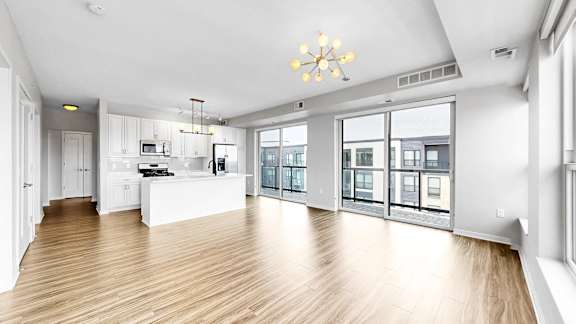 A spacious kitchen with wooden floors and a large island.