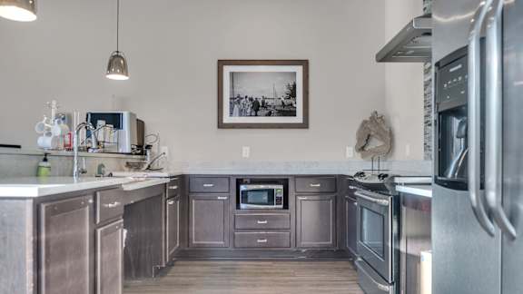 A kitchen with stainless steel appliances and wooden cabinets.