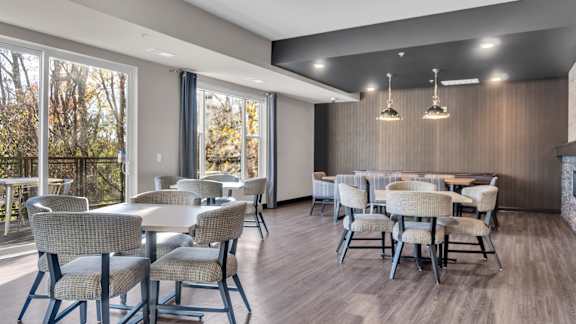 A dining room with a long table and chairs.