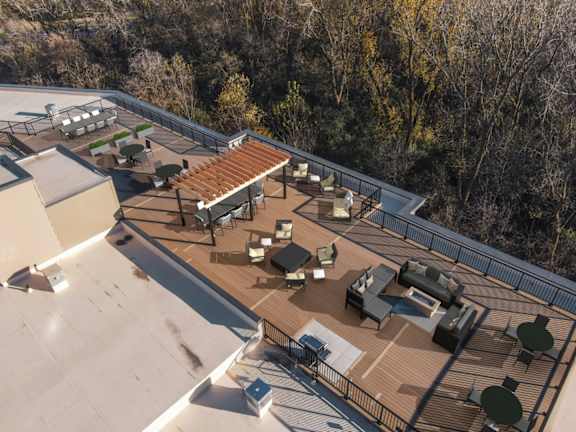 A rooftop patio with a table and chairs.