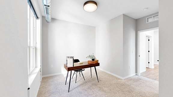 A room with a table and chairs in it.