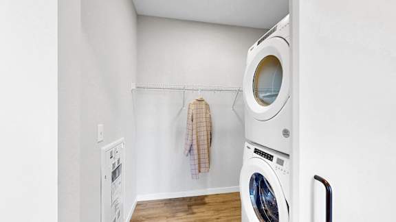 A white washing machine and dryer in a small laundry room.