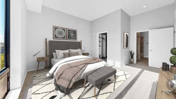 A modern bedroom with a large bed and a bench.