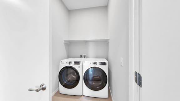 Two washing machines in a small laundry room.