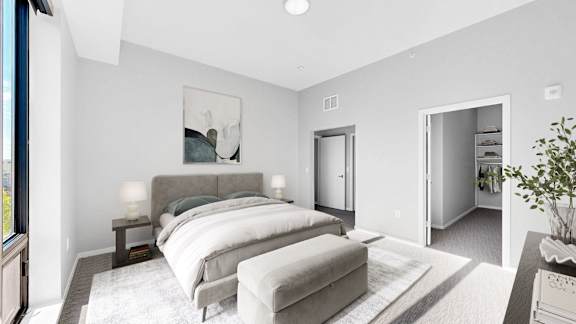 A bedroom with a large bed and a painting on the wall.