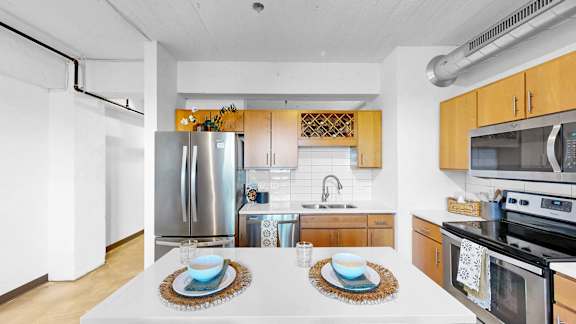A kitchen with a white table set for two.