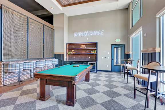 A pool table in a room with a checkered floor.