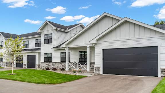 A modern house with a black garage door.