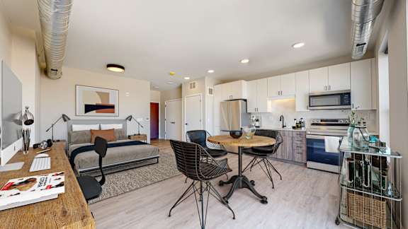 A modern kitchen with a dining table and chairs.