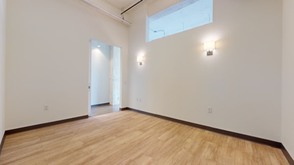 a large room with white walls and a wooden floor