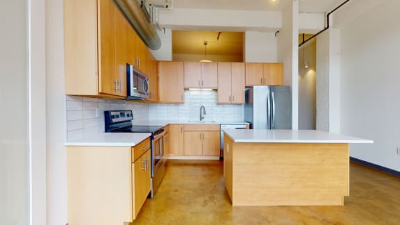 a kitchen with wooden cabinets and stainless steel appliances