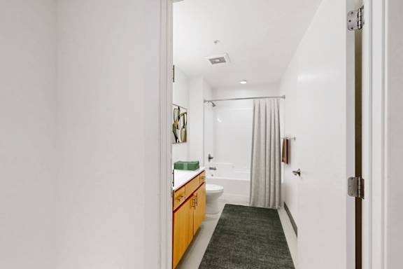 A bathroom with a toilet, sink, and shower.