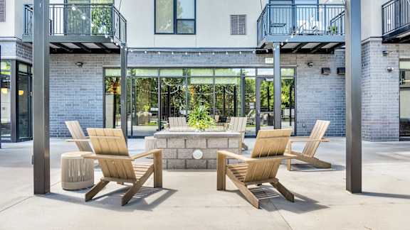 Two chairs and a table are on a patio.
