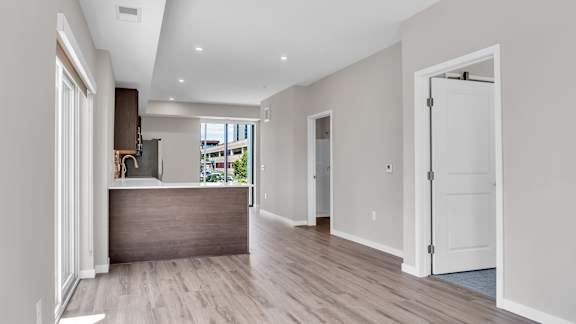A spacious room with a reception desk and a door leading to another room.