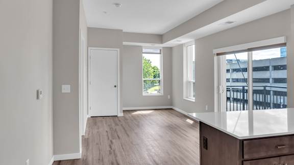A spacious room with a large window and a door.