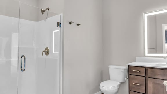 A white toilet sits next to a sink in a bathroom.