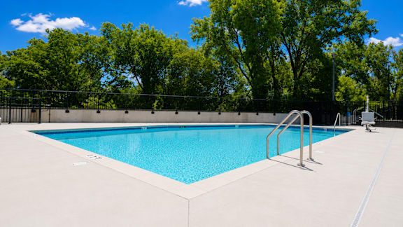 A rectangular pool with a metal ladder on the side.