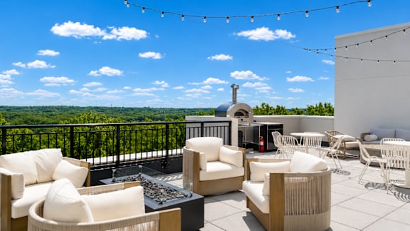 A patio with white furniture and a view of the sky.