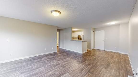 A room with wooden flooring and a white ceiling.