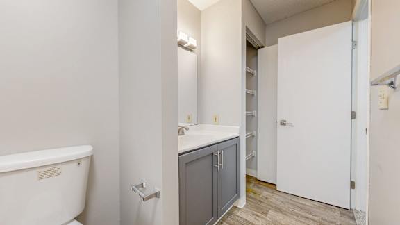 A white bathroom with a tub, sink, and medicine cabinet.
